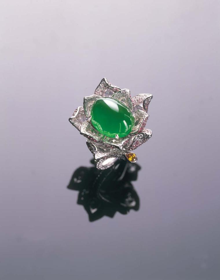 Samuel Kung showcases this almost translucent Imperial green cabochon jadeite stone by setting it in a diamond flower ring.